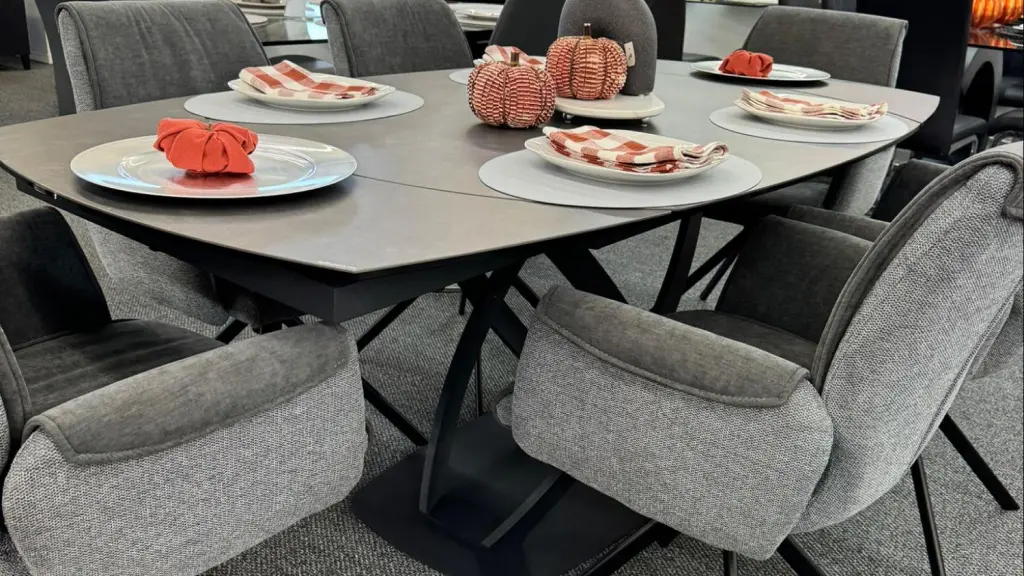 Thanksgiving table with six chairs and fabric pumpkins for festive decor