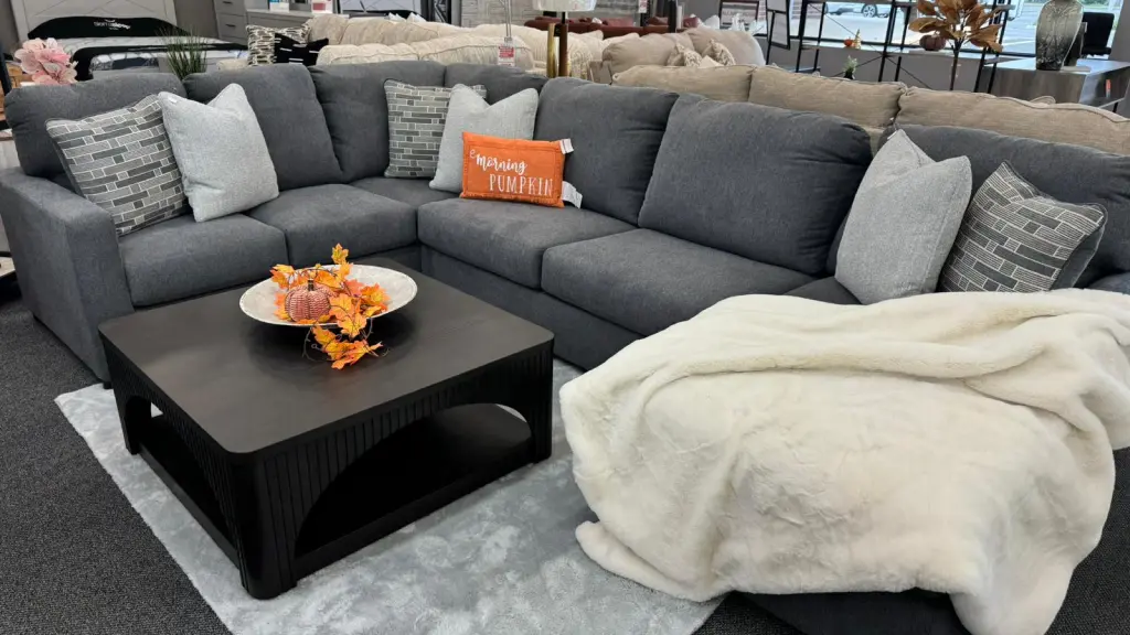 Sofa with blankets and cushions in warm and cozy tones