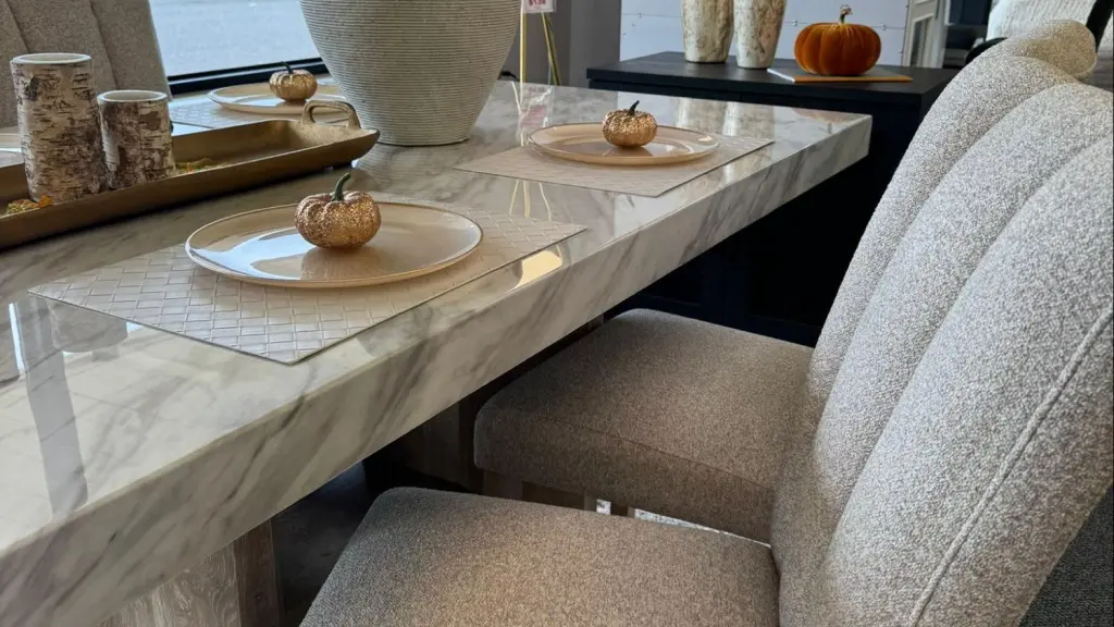 Stone dining table decorated with golden pumpkins for Thanksgiving