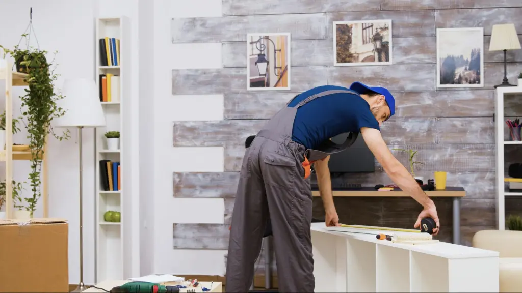 man measuring furniture during a move