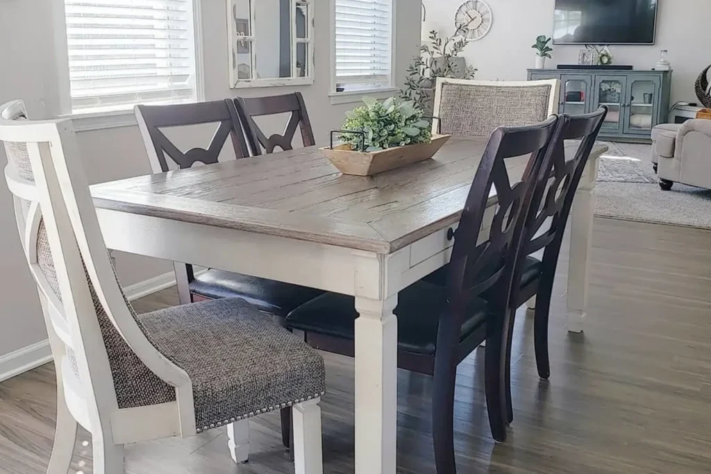 Elegant dining room decor featuring a wooden table set with upholstered chairs in a cozy, well-lit home interior